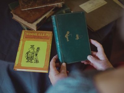 First edition Winne-the-Pooh being held with another book in background. Credit, 澳门七星图